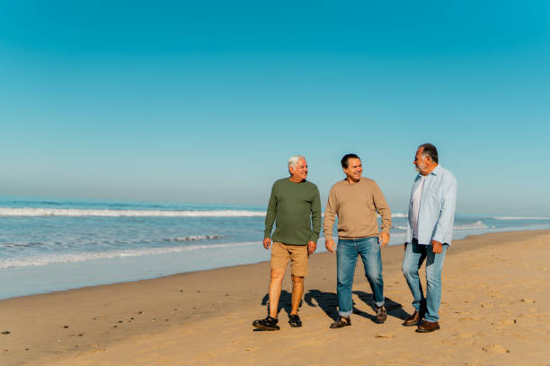 Senior friends talking through the beach