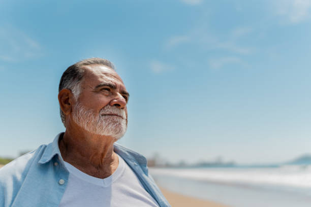 istock Senior man contemplating on the beach 2124940158
