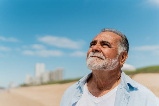 istock Senior man contemplating on the beach 2124940159