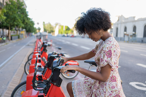 African American woman taking a bicycle in a bike sharing platform