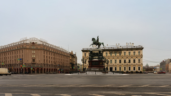 St. Petersburg, Russia, February 10, 2024. View of a large square in the city center with an equestrian statue of the emperor, beautiful buildings in a classical style, historical buildings, history and culture, city attractions, avenues and squares, transport, cityscape, winter.