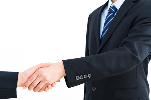 Businessman shaking hands against a white background