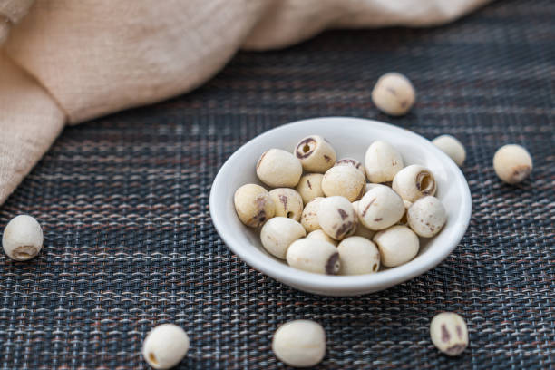 istock Many Lotus seeds spilled on the table 2125076014