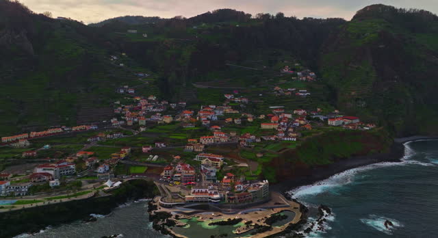 Aerial view of Porto Moniz town in Madeira island in Atlantic ocean, place where natural pools formed in volcanic rocks, Portugal