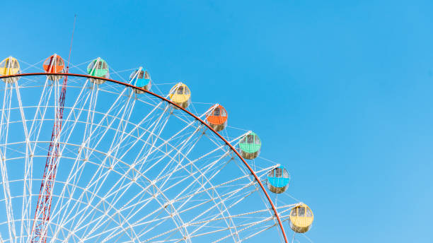 istock Close up of Ferris wheel under blue sky 2125113320