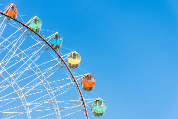 istock Close up of Ferris wheel under blue sky 2125114412
