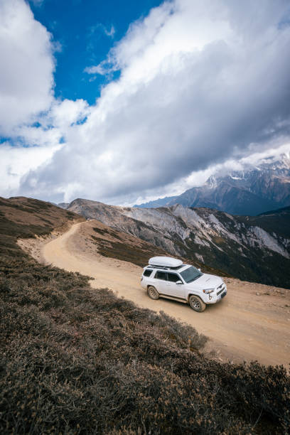 istock Driving car on high altitude mountain trail, China 2125117045