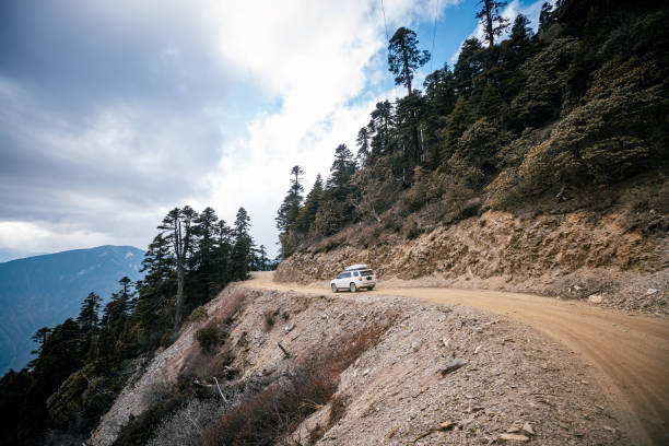 istock Driving car on high altitude mountain trail, China 2125118038