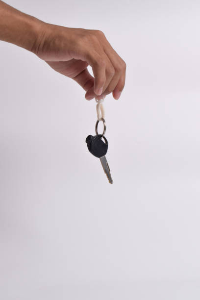 Car salesman handing keys to customer