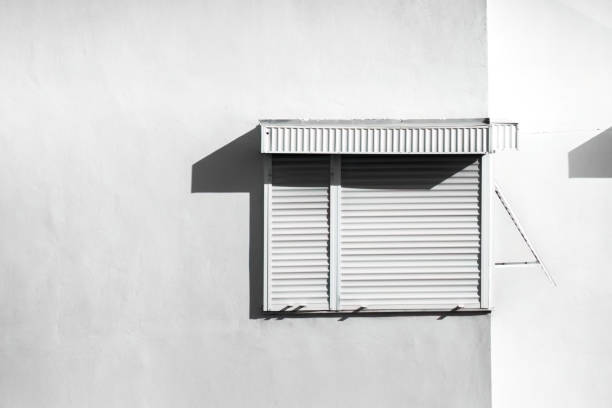 An apartment window and blinds. Window and shade.