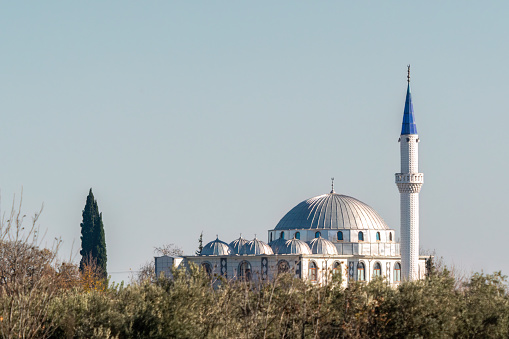 A white mosque and minaret. Mosque domes in Turkey
