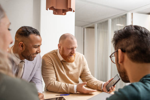 istock Four office colleagues during their daily duties in the building 2125131926