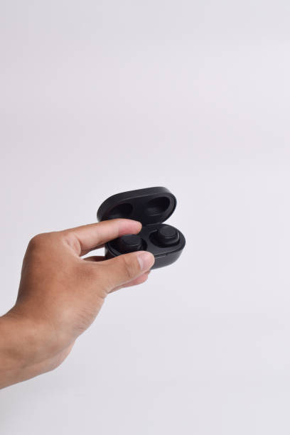 istock Hand holding Headphones wireless earphones with charging case 2125132134