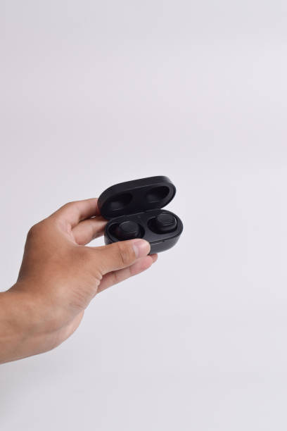 istock Hand holding Headphones wireless earphones with charging case 2125132138