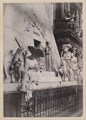 Historical view of Venice, Italy: Monument to Canova, in the Santa Maria Gloriosa dei Frari. In 1794 Antonio Canova designed and built a model for the tomb of Titian, but there were many difficulties in raising the necessary funds for the construction, so that in 1822, the year of Canova's death, it was still in draft form. Canova was buried in Possagno, his native country, the Academy of Fine Arts of Venice decided to build a monument to preserve the porphyry urn containing the heart of the artist; the work was undertaken by six of his students and completed in 1827. Original photograph (scanned and slightly restored) from the book 