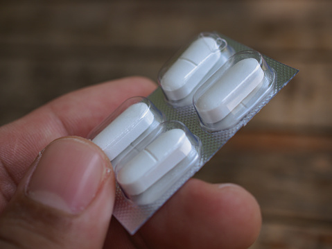 Various white blister packs of pills - white background