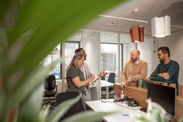 istock Four office colleagues during their daily duties in the building 2125138547