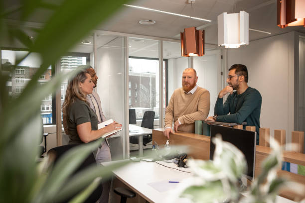 istock Four office colleagues during their daily duties in the building 2125138552