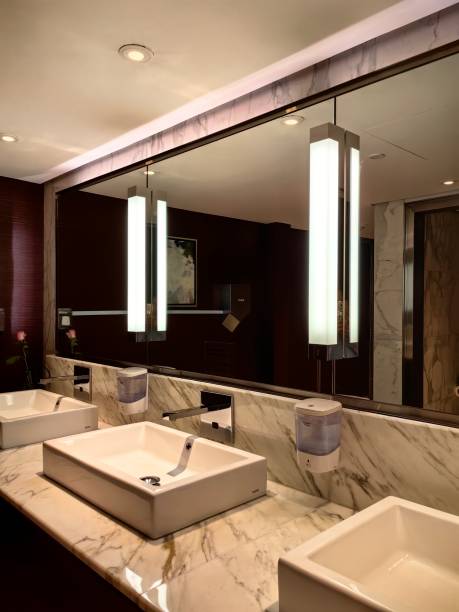 istock Toilet with rows of sinks and faucets 2125165336