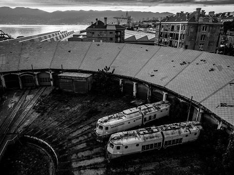 Rijeka, Croatia – March 26, 2024: The two old train cars with rust parked close together in an abandoned station