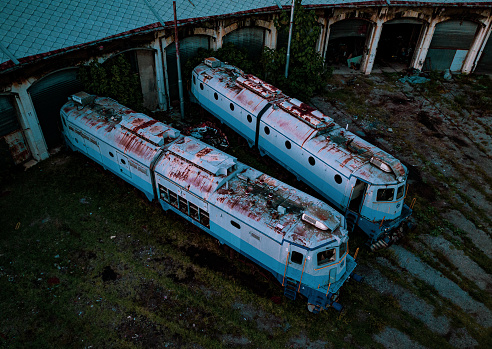 Rijeka, Croatia – March 28, 2023: The two old train cars with rust parked close together in an abandoned station