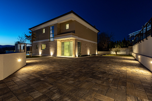 Linardici, Croatia – March 19, 2023: A stone house and driveway lit up at night
