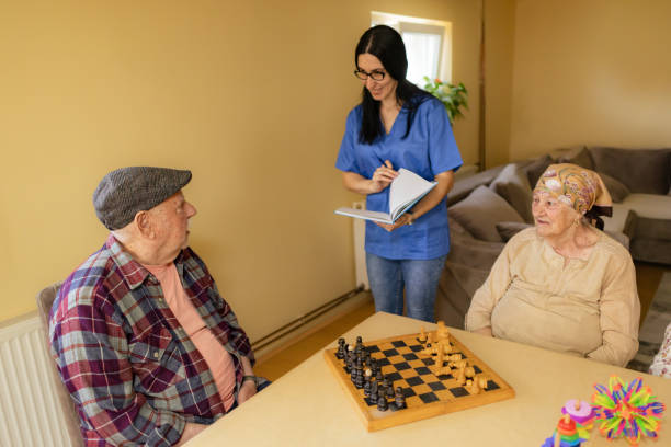 istock Elderly Chess Game with Nurse Observing 2125213254