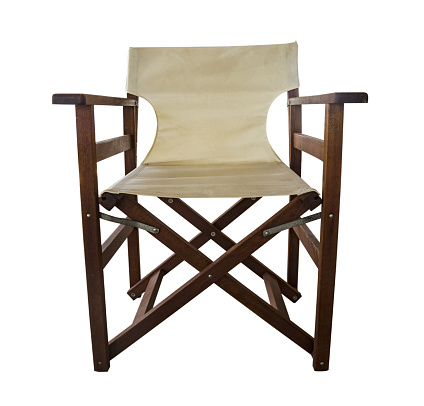 Modern folding wooden chair with fabric seat and backrest. White fabric seat and backrest armchair on white background.