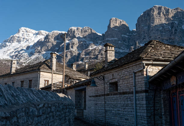 Traditional village in Greece Stone houses of traditional architecture and cobble-stone narrow street at the village of Papigo in Epirus, Greece in winter zagori stock pictures, royalty-free photos & images