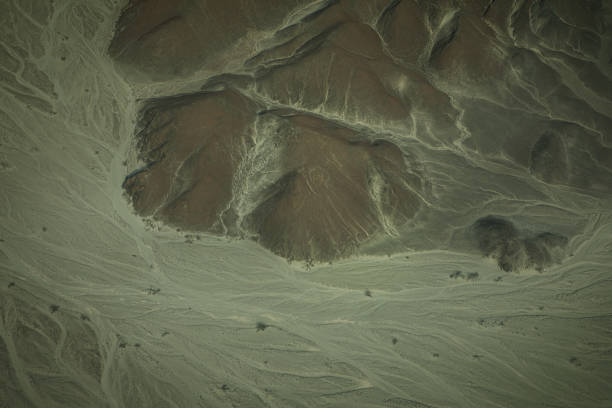 Charkent / Chahar Kint district, Balkh province, Afghanistan: rough landscape of Charkent Valley with scarps and ravines, road leading to Charkent gate.