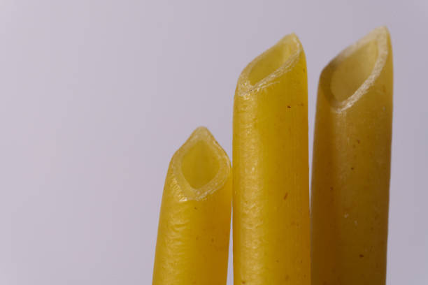 Macaroni wheat pasta on white background, typical Mediterranean cuisine