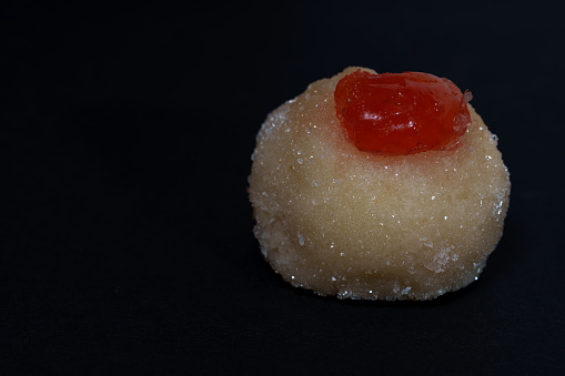 Sugared marzipan and cherry panellet with black background