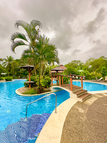 Idyllic Costa Rican pool and holiday resort located in the heart of the Jungle of the Central American country. The pool is empty as there is a rota of new guests arriving at the resort.