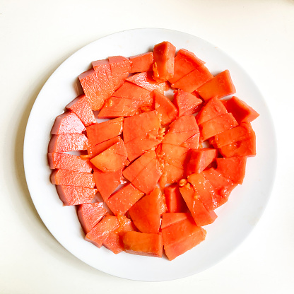 High angle view of a delicious ripe chopped papaya for dessert at home.