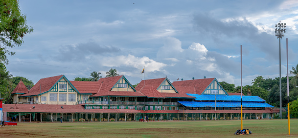 MUMBAI, INDIA - June 11, 2022 :  Bombay Gymkhana, lush green cricket club famous for its iconic pavilion. Colonial building.