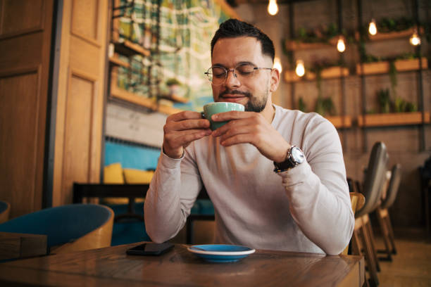 istock Picture of a handsome young man looking thoughtful while having coffee at a cafe. 2125419242
