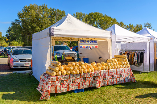 A popcorn and caramel popcorn tent and kiosk at an Autumn harvest festival in the rural countryside near Spokane, Washington, USA.