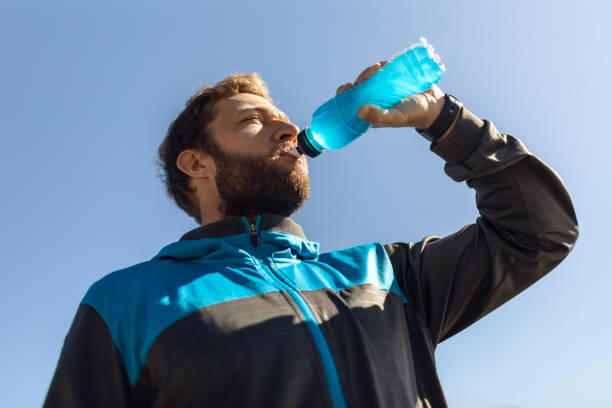 istock Athletic Runner Embracing Cardio Along the River Taking a Break Hydrating 2125459318