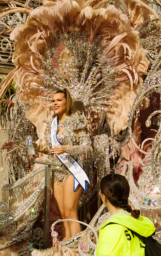 Las Palmas de Gran Canaria, Spain - February 17 2024: Carnival dame greets the public at grand carnival procession