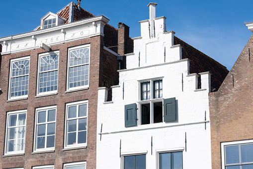Beautiful dutch canal houses at the herengracht in Amsterdam, the Netherlands, with a blue sky