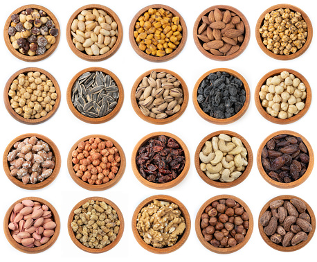Collection of healthy dried fruits, cereals, seeds and nuts isolated on white background.