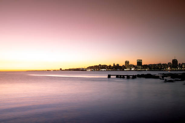 Sunset in a calm sea with Montevideo city in the background