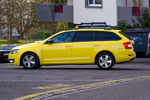 Yellow Skoda Octavia taxi at Swiss City of Zürich on a sunny spring day. Photo taken March 20th, 2024, Zurich, Switzerland.