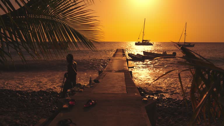 SLO MO Shot of Man Bathing near Jetty at Beach with Seascape in Background During Sunset