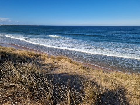 Baltic sea dunes over blue coastline background in Northern Germany