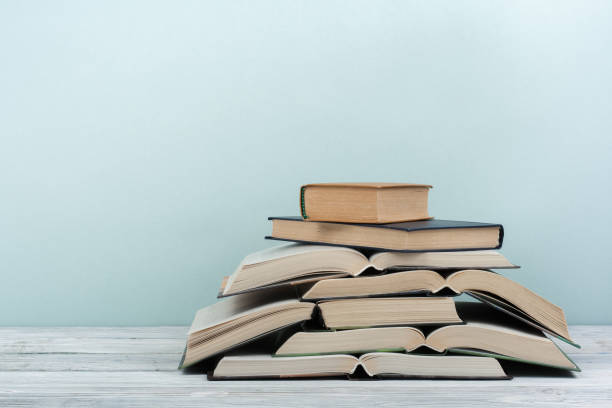istock Open book, hardback colorful books on wooden table. Back to school. Copy space for text. Education business concept. 2125648447