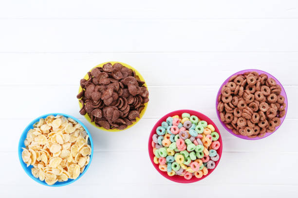 istock Various corn flakes in bowls on white wooden table 2125658240