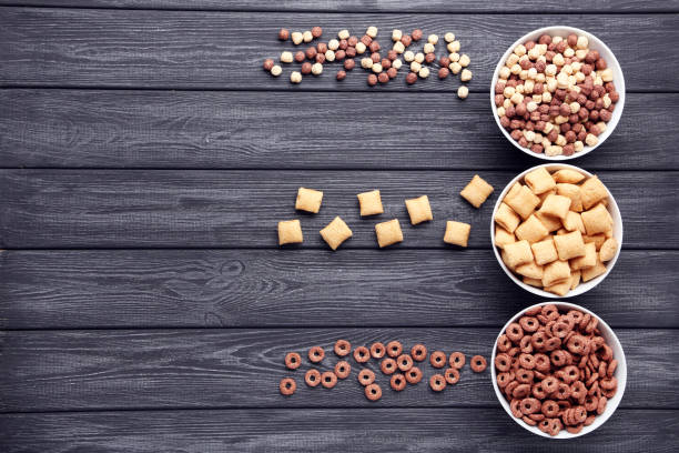 istock Various corn flakes in bowls on black wooden table 2125673159