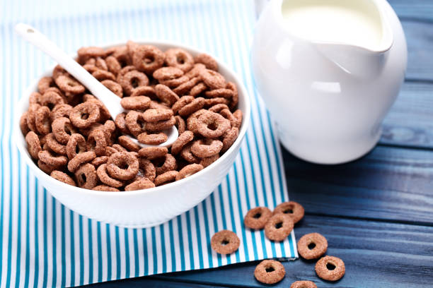 istock Chocolate corn flakes with milk in jar and spoon on blue wooden table 2125677825