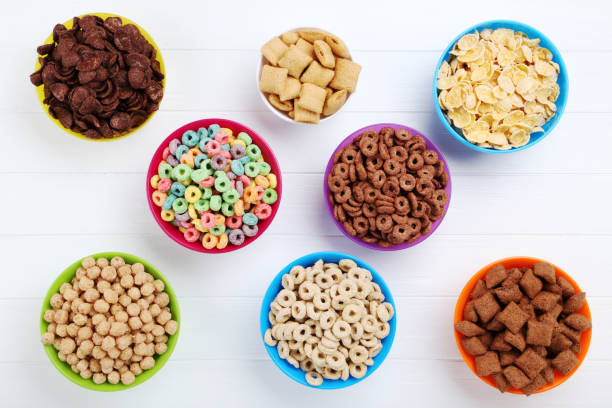istock Various corn flakes in bowls on white wooden table 2125679865